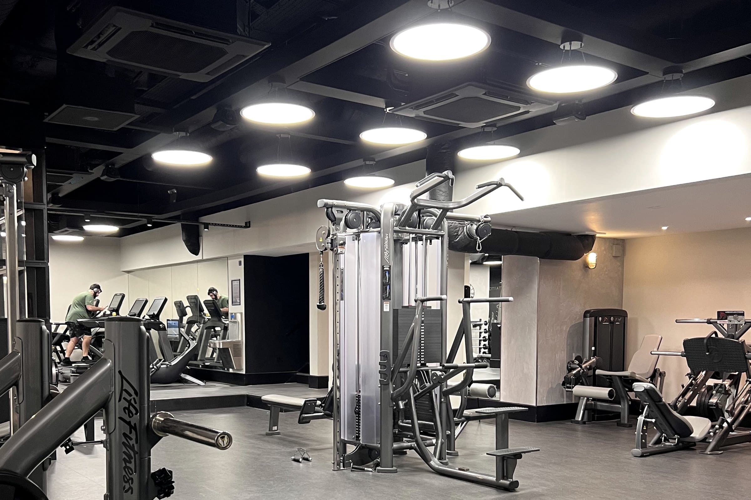 Open gym floor with cable machines and strength equipment